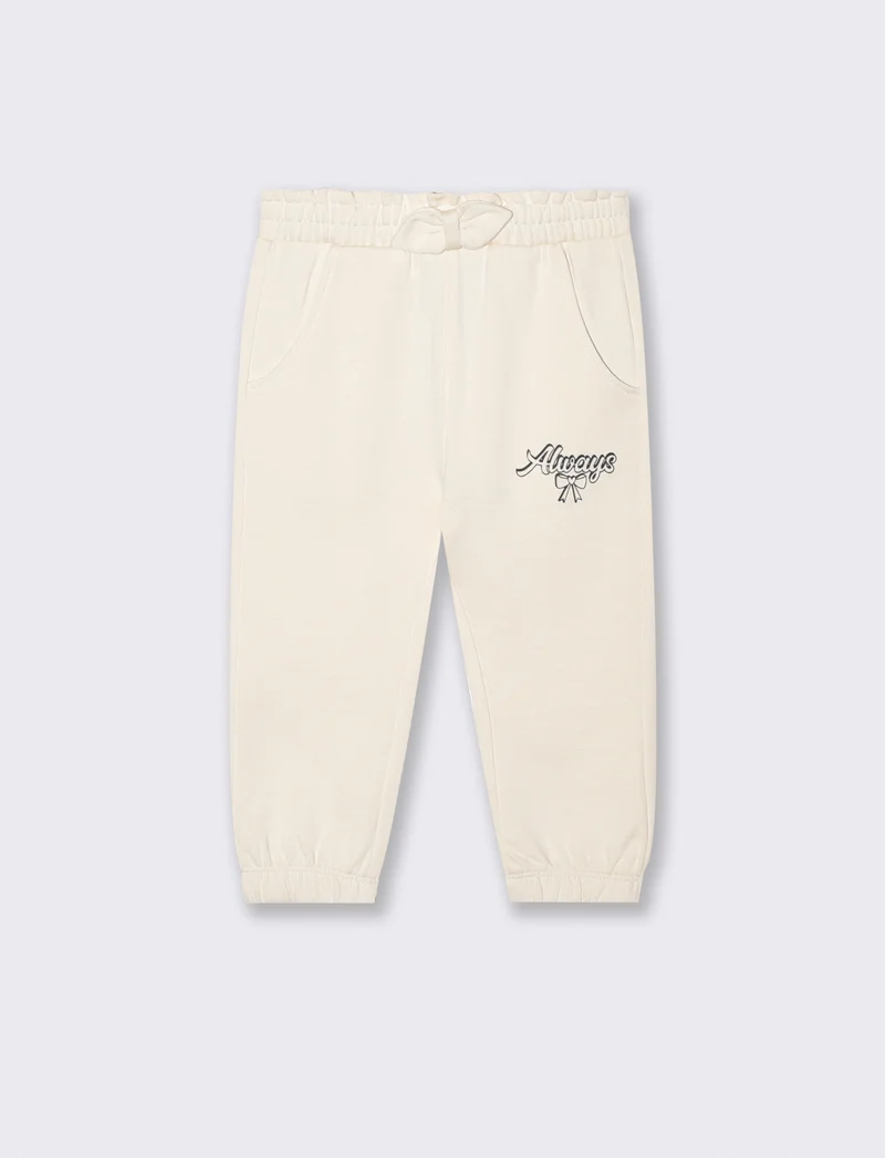 Jogger in cotone con fiocco e patch - Beige