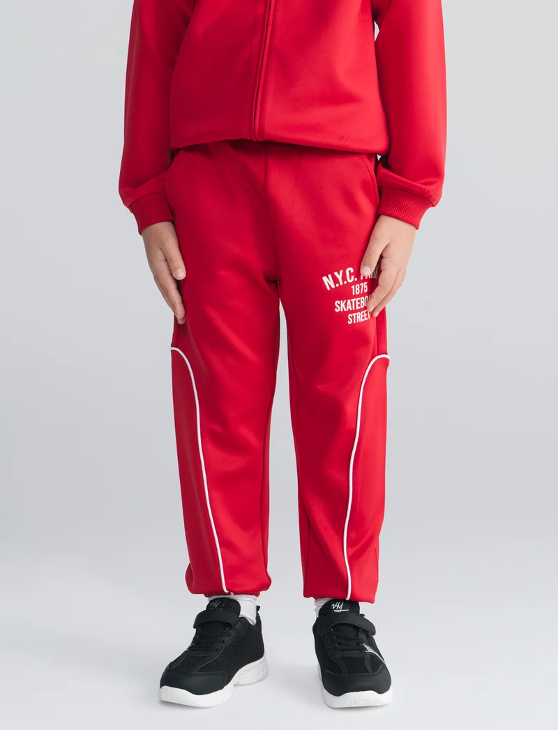 Jogger in felpa leggera con stampa frontale - Rosso india
